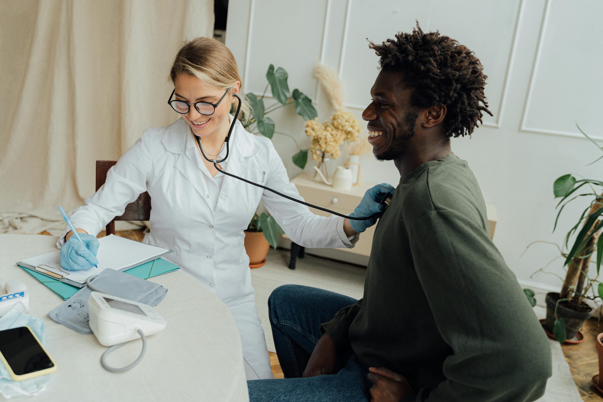 Doctor performing a heart and blood pressure screening.