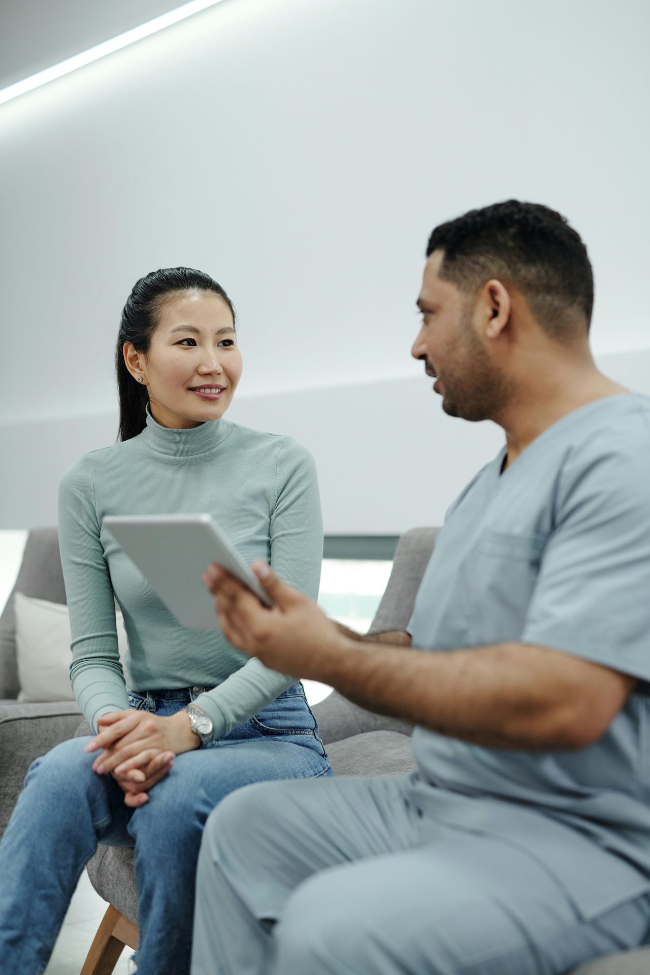Healthcare professional reviewing consultation details with a patient.