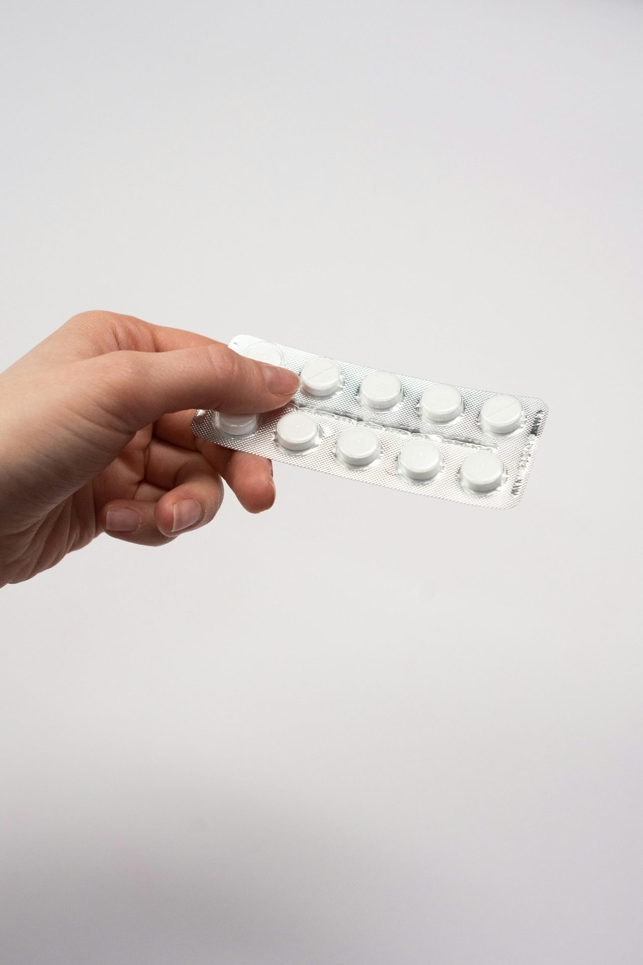 Medication blister pack representing review of treatment response and routine health follow-up.